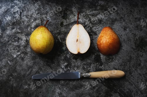 Preview: Fresh Home Grown Pears With A Rustic Knife Over Metal Background. Top View. Flat Lay.