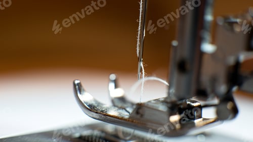 Preview: Machine Sewing Fabric, Needle With Thread In The Background.