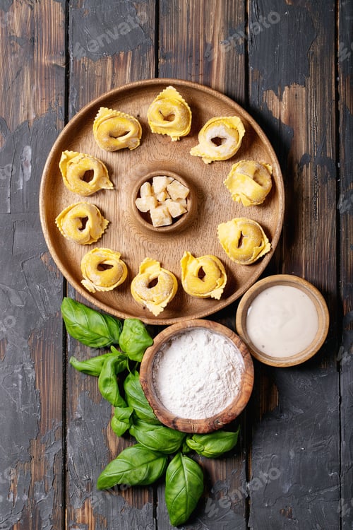 Preview: Raw Traditional Itallian Ravioli With Flour, Basiil, Egg And Salt On Wooden Board Over Dark Wooden