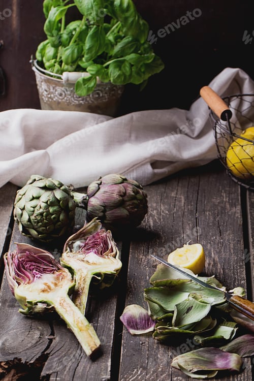 Preview: Ripe Organic Artichokes On The Rustic Wooden Board With Lemon, Napkin And Knife