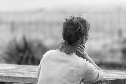 Preview: Woman Relaxing On A Bench, Back View.