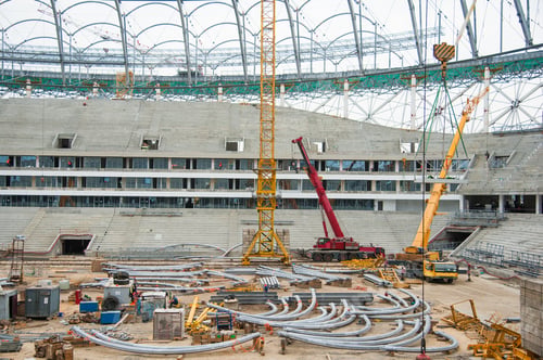 Preview: Stadium Construction. Construction Equipment And Workers On The Construction Of A Football Stadium