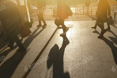 Preview: The Sun Shines On The Silhouettes Of Men And Women. People Go To Rush Hour In The City. A Lot Of