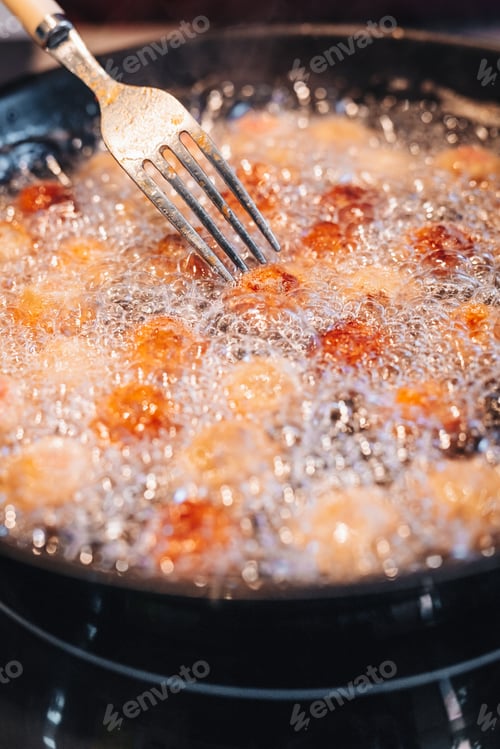 Preview: Frying Home Made Italian Traditional Meatballs With Parmesan And Bread