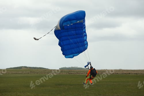 Preview: Skydiver Tries To Extinguish The Parachute Canopy After Landing In Windy Weather.
