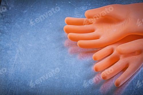 Preview: Pair Of Dielectric Rubber Gloves On Metallic Background Electricity Concept.