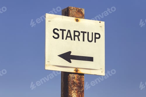 Preview: Startup Word And Arrow Signpost On Clear Sky Background. Motivational Sign. Vintage Style.