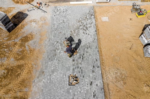 Preview: Worker Ramming Paving Slabs Top View