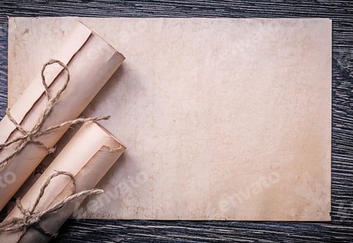Preview: Vintage Rolled Up Corded Paper On Wooden Background.