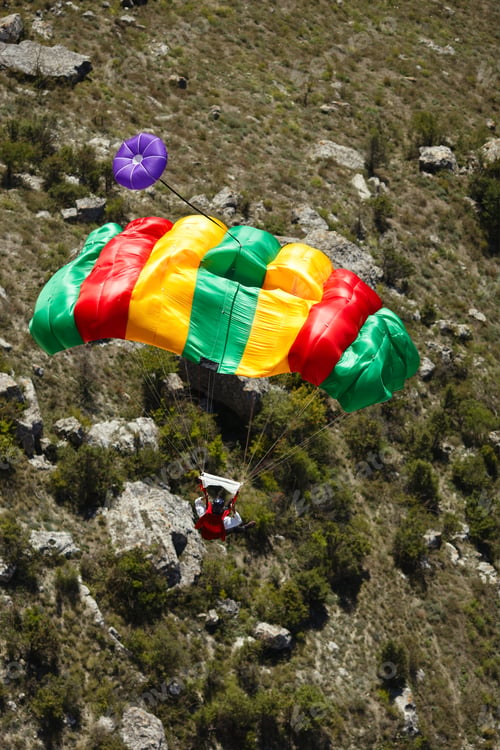 Preview: Figure Of A Base Jumper Under A Parachute After A Hard Opening Of The Canopy, Against The