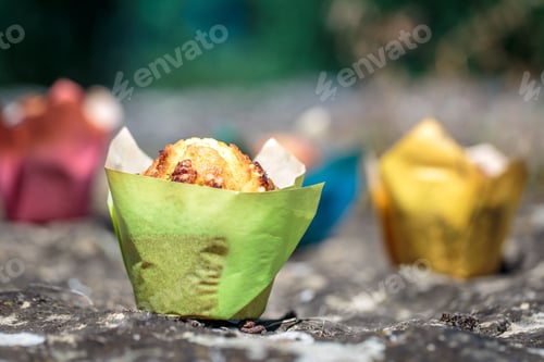 Preview: Colorful Muffins Sitting on a Stone Surface