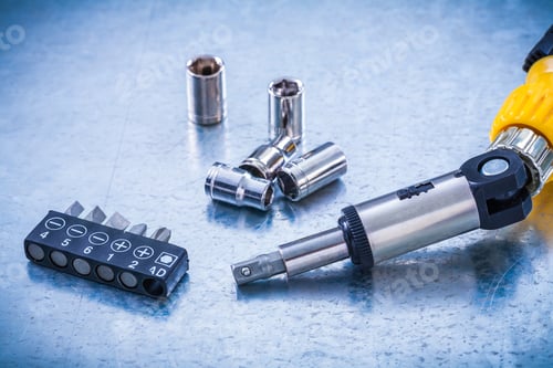 Preview: Set Of Reversive Turnscrew Screwdriver Bits And Torx On Metallic Background Construction Concept.