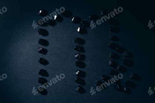 Preview: Symbol Of The Zodiac Sign Virgo Made By Black Stones On A Black Background. Low Dark Key