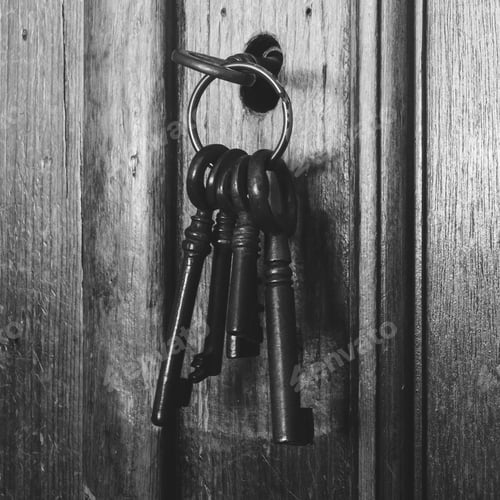 Preview: Old Rusty Keys Inside A Keyhole Of An Old Antique Closet. Vintage Design Close-Up Black And White