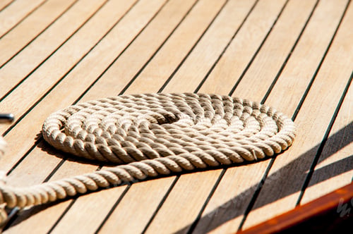 Preview: Rope Neatly Coiled On The Wooden Deck Of A Boat.