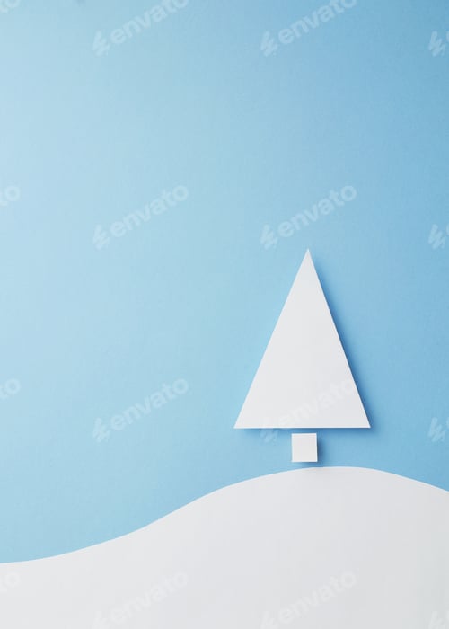 Preview: Paper Christmas Tree Cut From White Paper Over Blue Background, Top View
