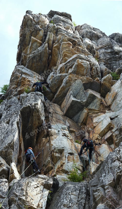 Preview: Participants Of Climbing Competitions Pass Routes On A Rock Tower, Vertical Panorama.