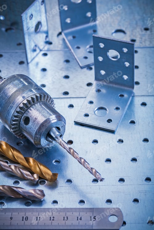 Preview: Angle Fasteners Bits Ruler And Metal Drill On Perforated Metallic Background Construction Concept.