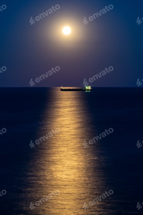 Preview: Cargo Ship At Night With Full Moon Over The Horizon