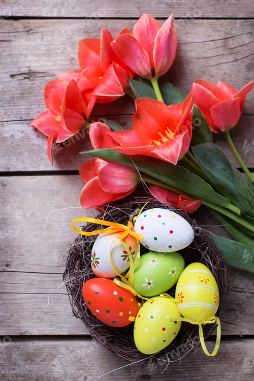 Preview: Easter Composition. Fresh Tulips Flowers, Decorative Eggs In Nest On Vintage Wooden Background