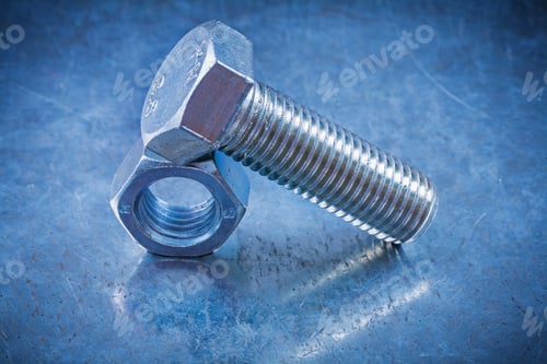 Preview: Threaded Screwbolt And Construction Nut On Metallic Background Top View.