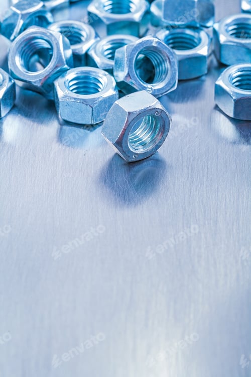 Preview: Vertical View Of Stainless Screw Nuts On Metallic Background Construction Concept