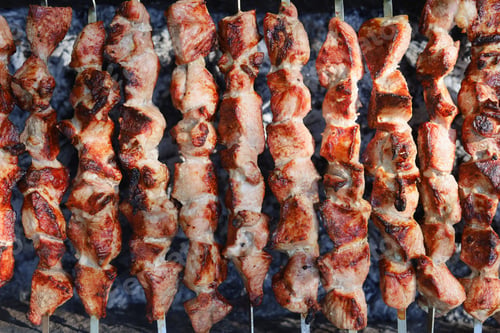 Preview: The Process Of Frying Pork Meat On The Grill. Skewers With Barbecue. Selective Focus. Blurred