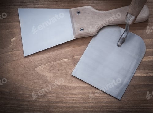 Preview: Stainless Putty Knife Bricklaying Trowel On Wooden Background Construction Concept.