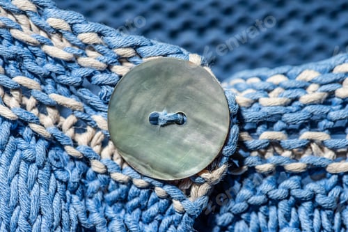 Preview: A Button On A Blue Knitted Sweater.