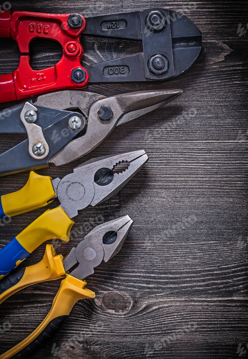 Preview: Stainless Wire Steel Cutter Pliers On Wooden Board Construction Concept.
