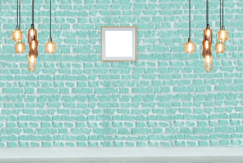 Preview: Teal brick wall with decorative lights and frame