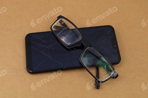 Preview: Broken Glasses And Smartphone. Selective Focus. Background