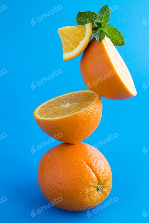 Preview: Oranges Fruit Stacked Pyramid On The Blue Background. Location Vertical.