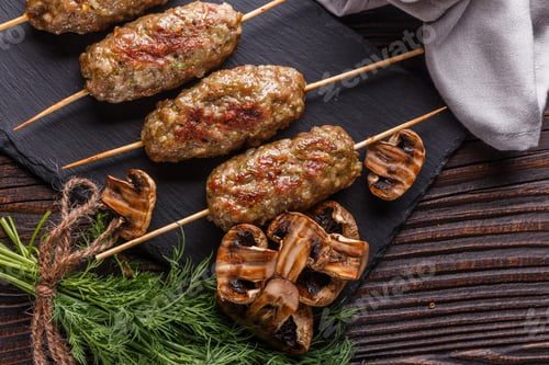 Preview: Shish Kebab On The Skewers With Grilled Mushrooms On Rustic Table