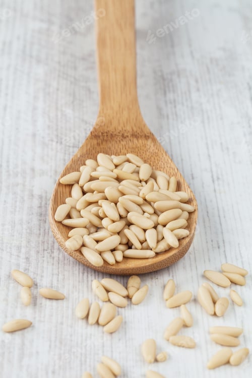Preview: Fresh Raw Pine Nuts On A Wooden Spoon On The Table