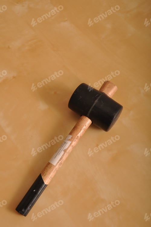 Preview: Rubber Hammer On A Brown Wooden Background