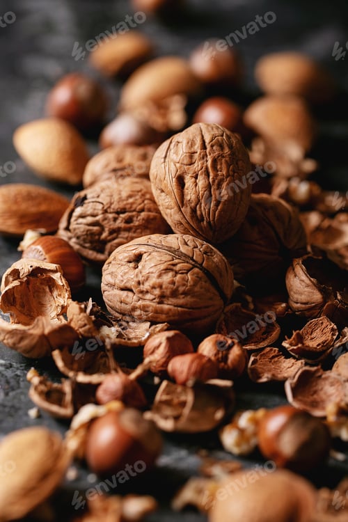 Preview: Varieties Of Nuts: Almonds, Hazelnuts And Walnuts Over Dark Texture Background