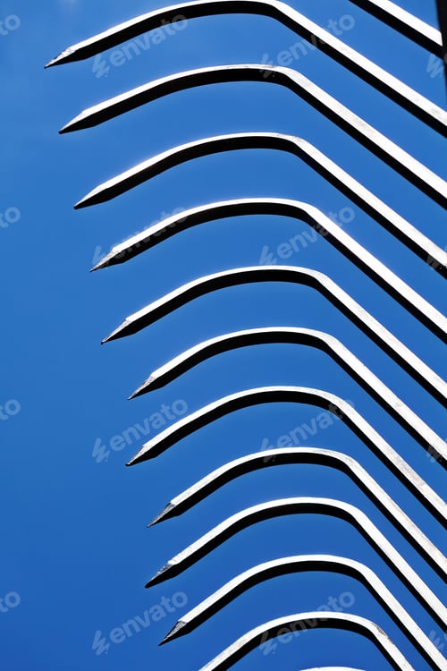 Preview: Sharp Metal Fence Pikes Against Blue Sky