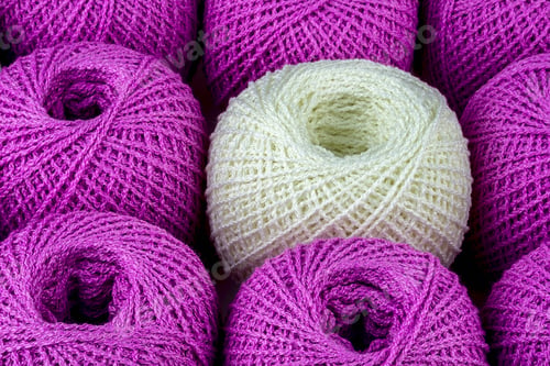 Preview: One White Ball Of Yarn Among Purple Balls