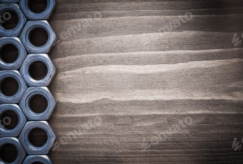 Preview: Steel Threaded Construction Nuts On Vintage Wooden Surface Construction Concept.