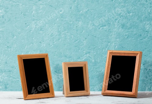 Preview: Wooden Photo Frames On Table, Blue Wall