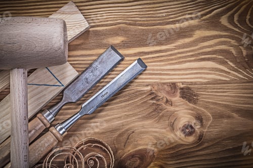 Preview: Wooden Hammer Bricks Flat Chisels Planning Chips On Vintage Wood Board.