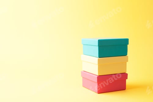 Preview: Stack Of Gift Boxes Over Yellow Background