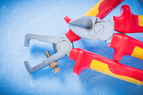 Preview: Insulated Wire Strippers Sharp Nippers On Blue Background Electricity Concept.