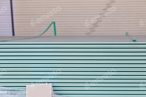 Preview: A Stack Of Drywall Sheets Is Stored In A Wholesale Warehouse. Selective Focus With Blurred