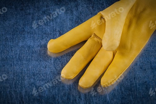 Preview: Leather Safety Glove On Scratched Metallic Background Construction Concept.