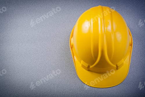 Preview: Yellow Safety Building Helmet On Grey Background Construction Concept.