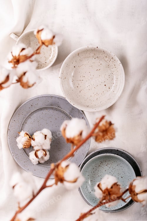 Preview: Dinner Place Setting. A Blue Modern Ceramic Plate Decorated With Cotton Flower Over White Textile