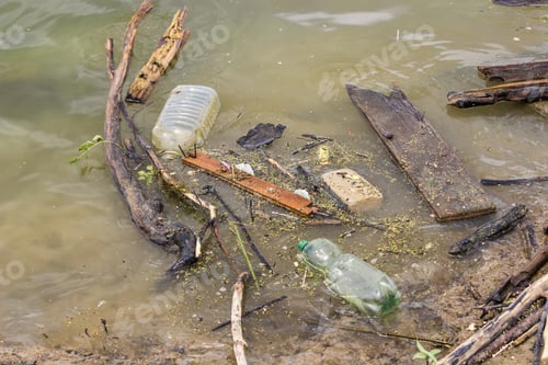 Preview: Plastic Bottles And Garbage Waste On The Shore Of A River. Selective Focus.