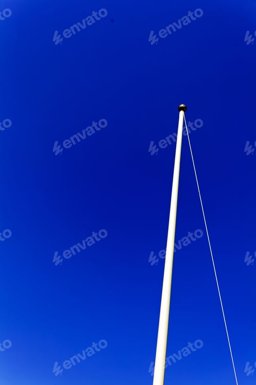 Preview: Single Flagpole With No Flag, On Blue Sky Background